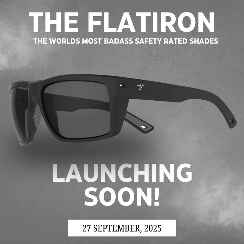 Close-up of the Flatiron sunglasses resting on a rock, highlighting the sleek wraparound frame and polarized Zeiss lenses